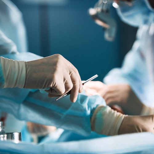 surgeon using tools in theatre.